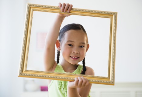 Korean girl holding empty picture frame