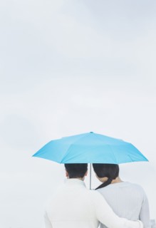 Couple hugging under umbrella