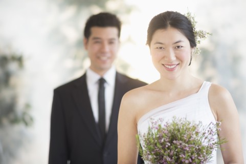 Newlywed bride holding bouquet at wedding