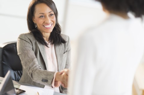African American businesswomen shaking hands
