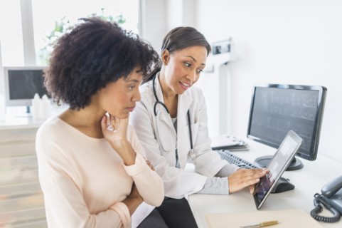 African American doctor and patient talking in office