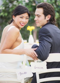 Newlywed couple sitting together at wedding reception