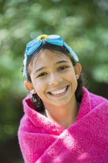 Mixed race girl wrapped in towel