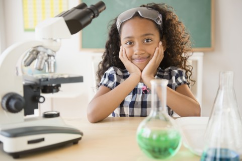 Mixed race student smiling in chemistry lab
