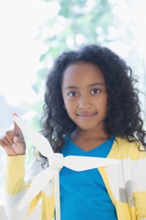 Mixed race girl with model wind turbine