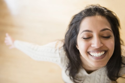 Close up portrait of carefree Asian woman with eyes closed