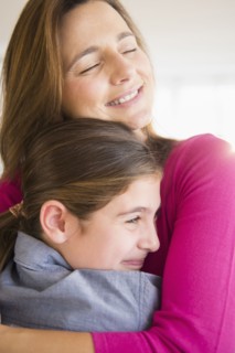 Close up of Caucasian mother and daughter hugging