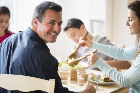 Caucasian family eating at table