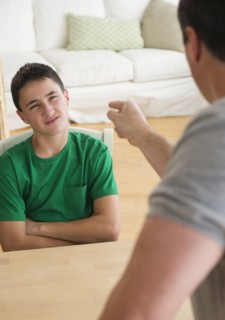 Caucasian father scolding angry son