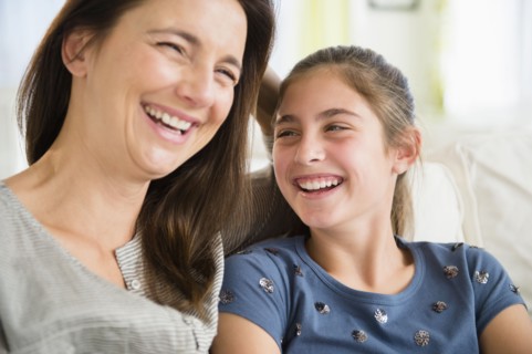 Close up of Caucasian mother and daughter laughing