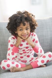Portrait of smiling African American girl in pajamas