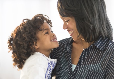 African American mother and daughter hugging and smiling