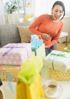 Pregnant Japanese woman looking at baby shower gifts
