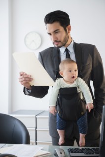 Businessman working with baby in office