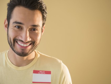 Mixed race man wearing name tag
