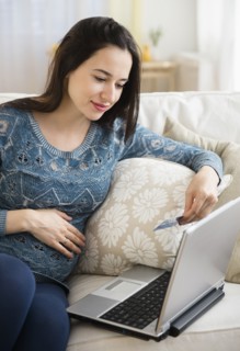 Pregnant Caucasian woman shopping online