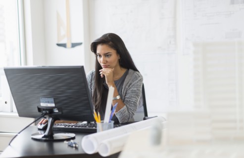 Hispanic businesswoman working in office