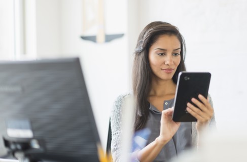 Hispanic businesswoman using digital tablet in office