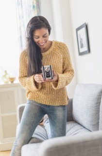 Hispanic woman using vintage camera
