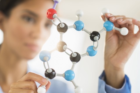 Hispanic scientist examining molecular model