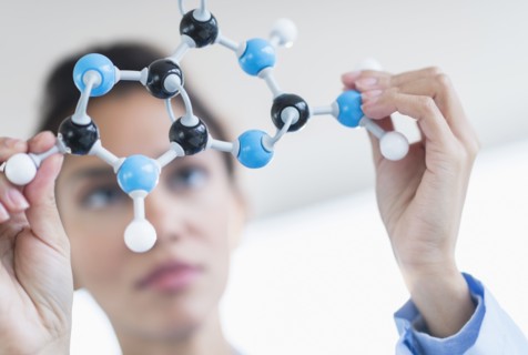 Hispanic scientist examining molecular model