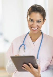 Hispanic nurse using digital tablet in hospital