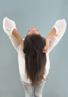 Hispanic woman with long hair leaning back