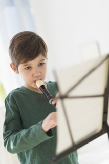 Hispanic boy practicing recorder