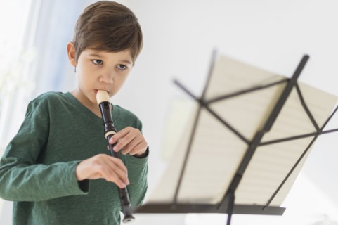 Hispanic boy practicing recorder
