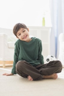 Hispanic boy smiling in living room