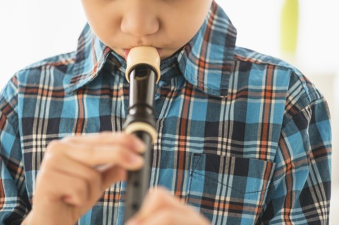 Hispanic boy practicing recorder