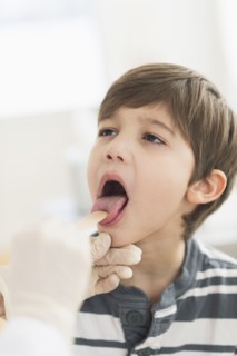 Hispanic boy getting a checkup at doctor's office