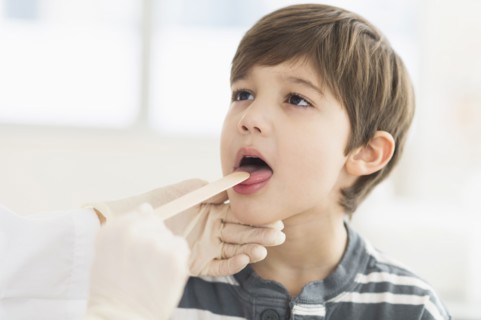 Hispanic boy getting a check up at doctor's office
