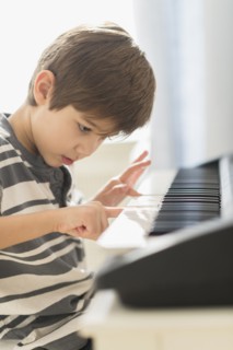 Hispanic boy practicing piano