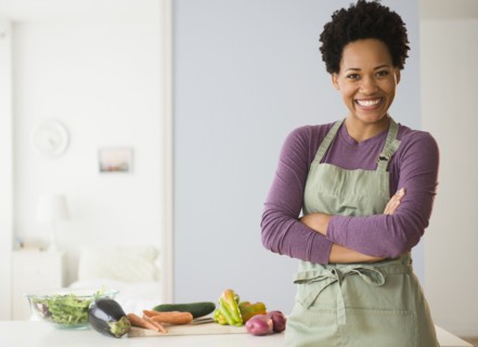 Portrait of black woman cooking in kitchen