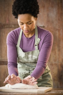 Black woman kneading dough