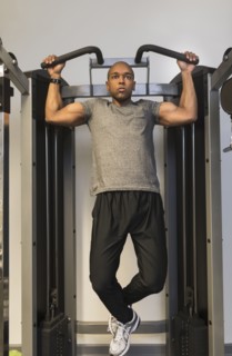 Black man lifting weights in gym