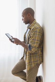 Black man using digital tablet