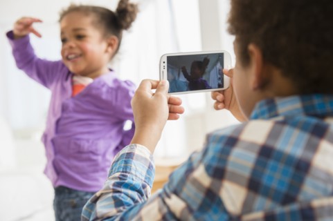 Black children playing with cell phone