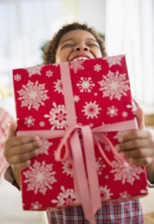 Black boy holding Christmas present