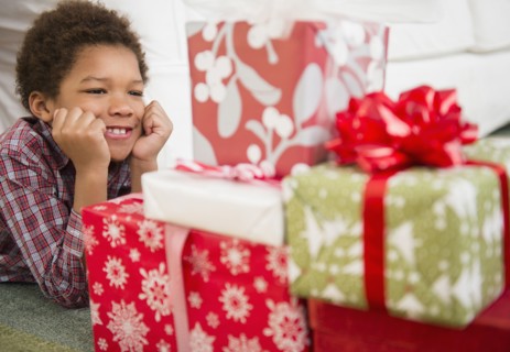 Black boy admiring Christmas presents