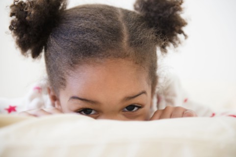 Black girl playing on bed