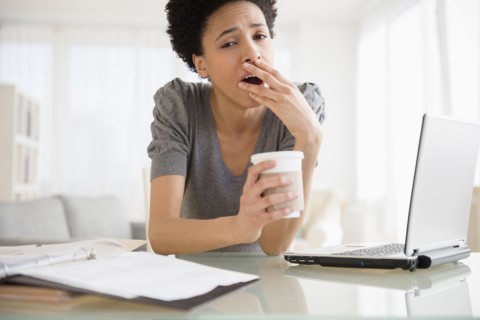 Black woman yawning at desk