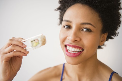Black woman eating sushi