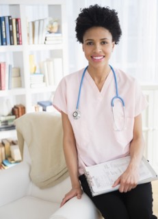 Black nurse smiling at home visit