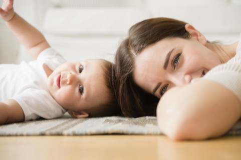 Mother and baby playing in living room
