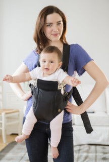 Mother carrying baby in sling