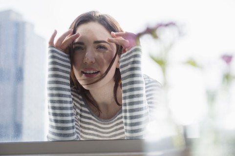 Woman peering in through window