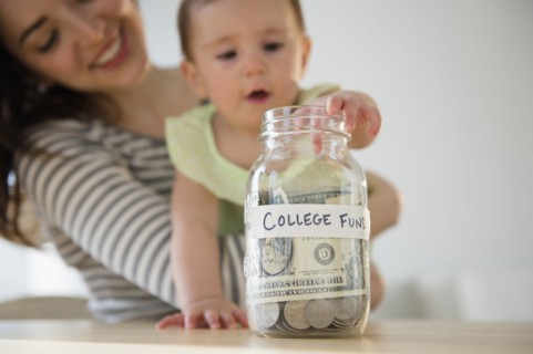 Mother and baby putting money in college fund