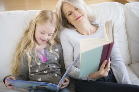 Senior Caucasian woman and granddaughter reading together